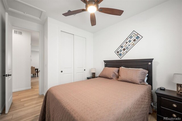 9157 Rio Lado St, Littleton, CO 80125 - bedroom featuring light wood finished floors, attic access, a closet, baseboards, and a ceiling fan