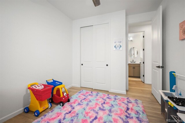 9157 Rio Lado St, Littleton, CO 80125 - playroom with light wood finished floors, baseboards, and ceiling fan