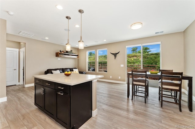 15061 W 70th Ave, Arvada, CO 80007 - kitchen with light countertops, light wood finished floors, baseboards, and recessed lighting