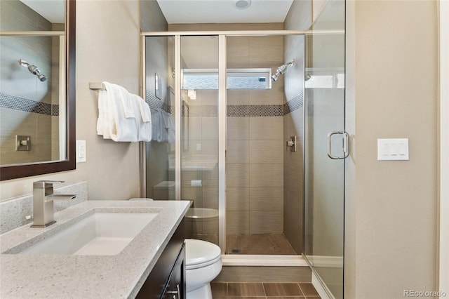 15061 W 70th Ave, Arvada, CO 80007 - full bath featuring toilet, vanity, a shower stall, and tile patterned floors