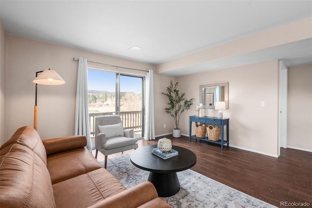 living area featuring baseboards and wood finished floors