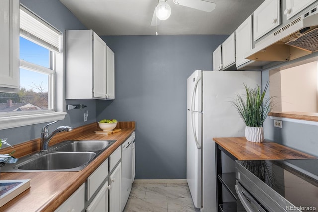 kitchen with a sink, marble finish floor, under cabinet range hood, and white cabinets