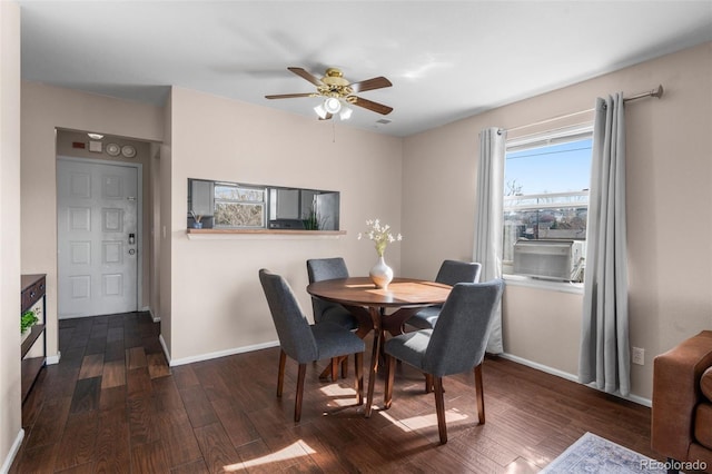 dining space featuring baseboards, cooling unit, a ceiling fan, and dark wood-style floors