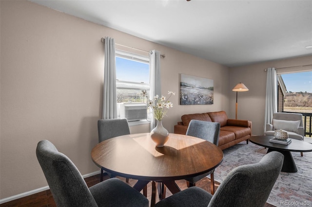 dining area with plenty of natural light, baseboards, wood finished floors, and cooling unit