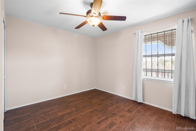 unfurnished room with dark wood-style flooring, ceiling fan, and baseboards