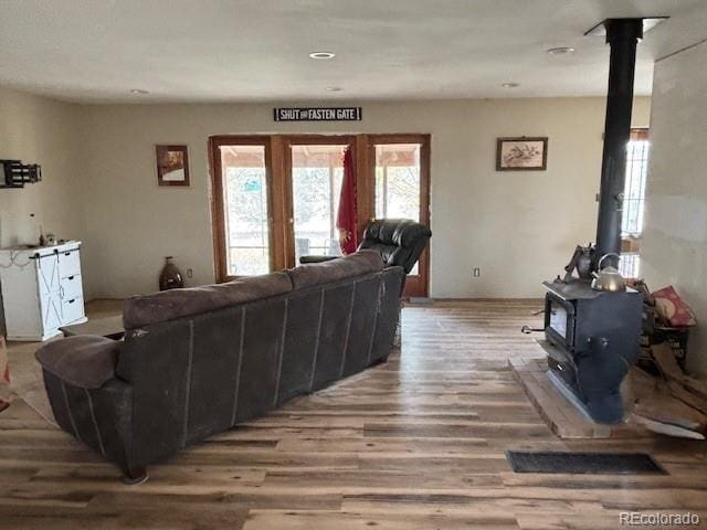 9707 County Lane 22.5, Sugar City, CO 81076 - living room with a wood stove and wood finished floors