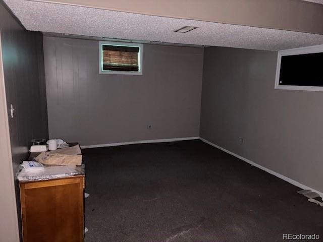 9707 County Lane 22.5, Sugar City, CO 81076 - finished below grade area featuring dark colored carpet and baseboards
