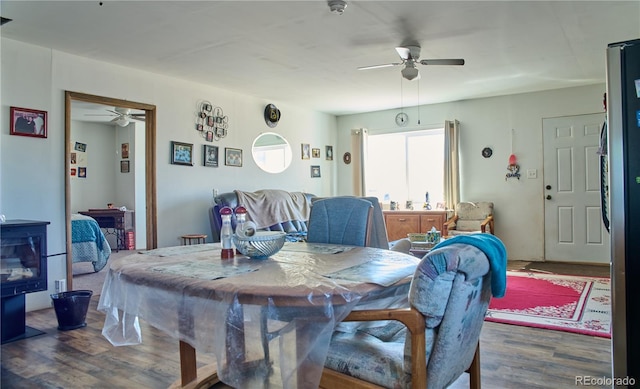 dining space with wood finished floors and ceiling fan