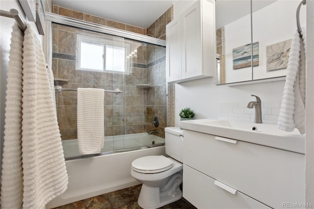 12235 Garfield Pl, Thornton, CO 80241 - full bathroom featuring vanity, combined bath / shower with glass door, and decorative backsplash