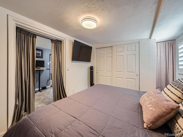 4747 S Elati St, Englewood, CO 80110 - bedroom with a textured ceiling, a closet, and carpet
