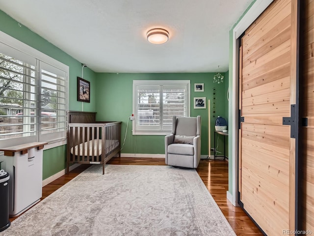 4747 S Elati St, Englewood, CO 80110 - bedroom featuring wood finished floors and a crib