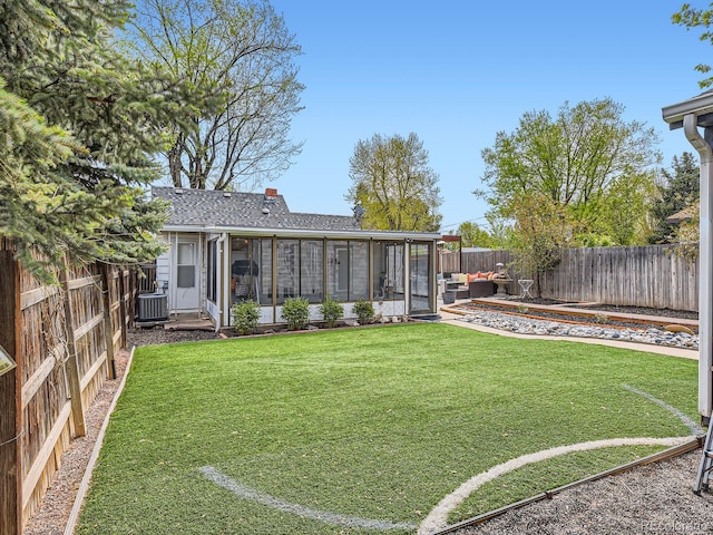 4747 S Elati St, Englewood, CO 80110 - back of house featuring a fenced backyard, a sunroom, roof with shingles, and a chimney
