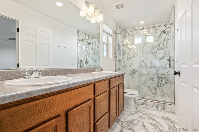 bathroom featuring vanity, an enclosed shower, and toilet