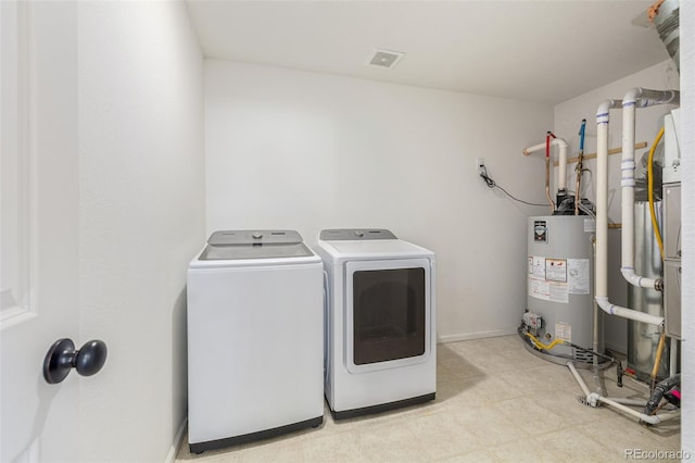 laundry area with washer and clothes dryer and gas water heater