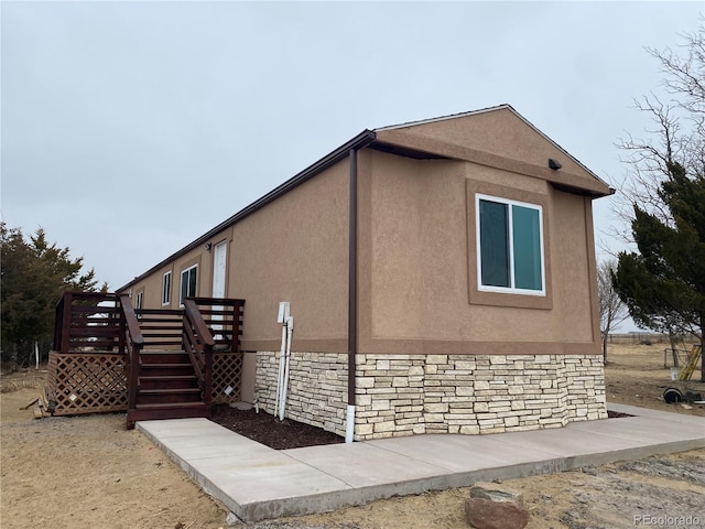 view of home's exterior featuring a wooden deck