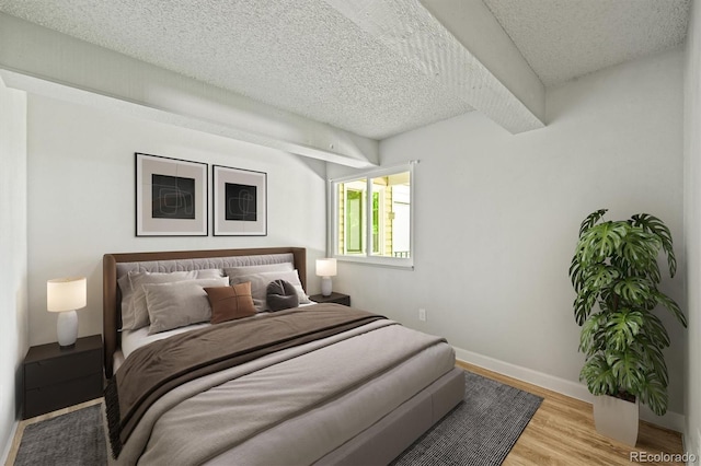 2678 S Xanadu Way Unit C, Aurora, CO 80014 - bedroom with a textured ceiling and light wood-style floors