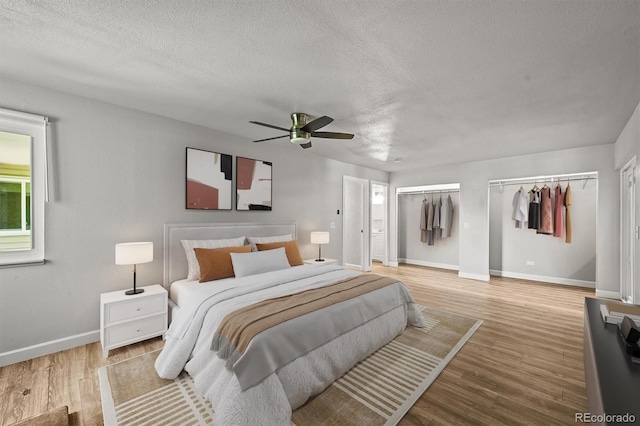2678 S Xanadu Way Unit C, Aurora, CO 80014 - bedroom featuring a textured ceiling, wood finished floors, ceiling fan, and ensuite bathroom