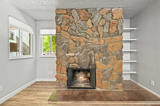 2678 S Xanadu Way Unit C, Aurora, CO 80014 - detailed view of a textured ceiling, a fireplace, and wood finished floors