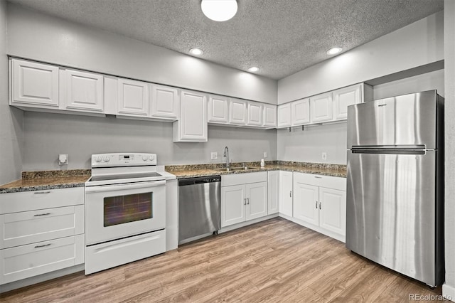 2678 S Xanadu Way Unit C, Aurora, CO 80014 - kitchen with appliances with stainless steel finishes, a textured ceiling, white cabinetry, recessed lighting, and light wood-style flooring