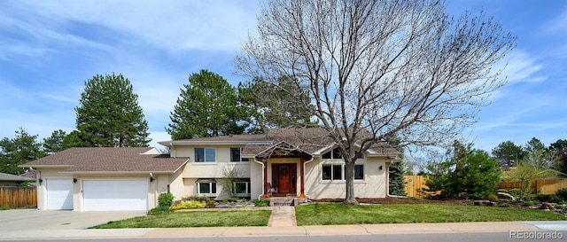 view of front of property featuring an attached garage, stucco siding, and driveway