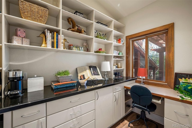 office featuring wood finished floors, built in study area, and lofted ceiling