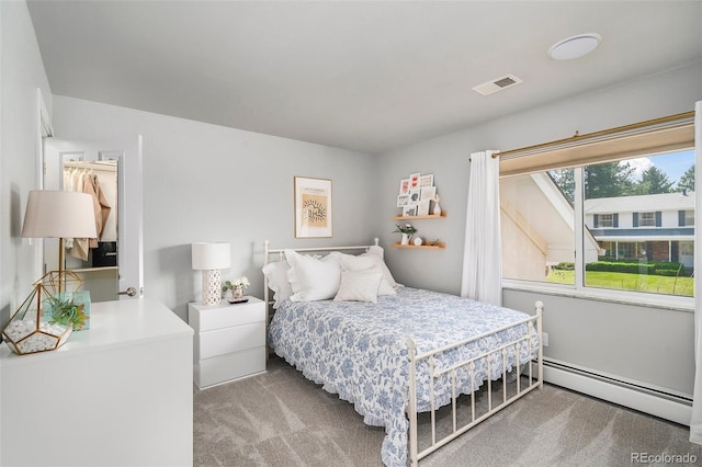 bedroom with a baseboard radiator and carpet floors