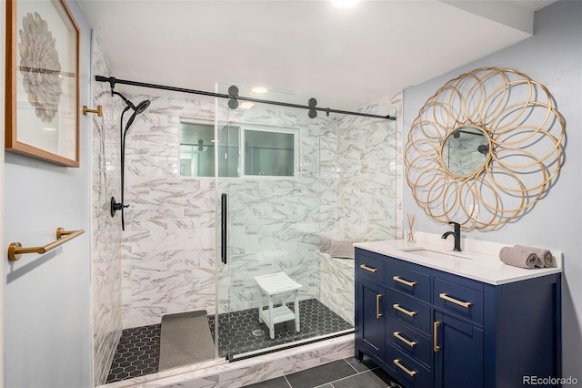 full bath featuring a shower stall, vanity, and tile patterned flooring