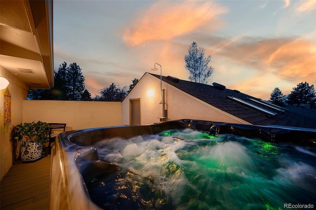 view of swimming pool with a hot tub