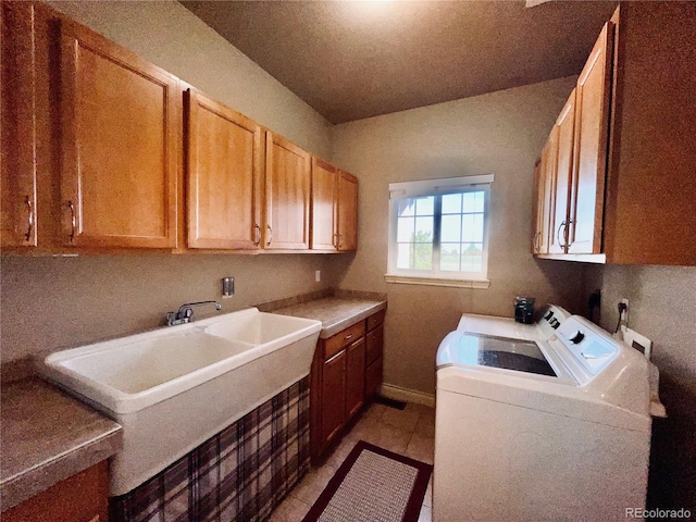 690 Antelope Dr, Bennett, CO 80102 - washroom with cabinet space, washer and dryer, and light tile patterned floors