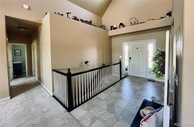 690 Antelope Dr, Bennett, CO 80102 - foyer entrance with baseboards and high vaulted ceiling