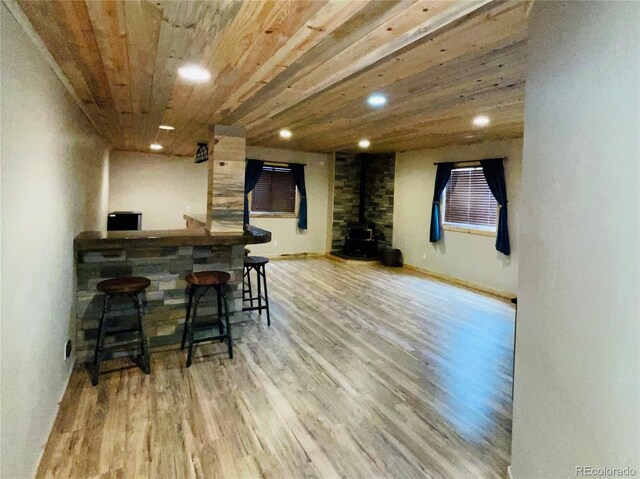 690 Antelope Dr, Bennett, CO 80102 - indoor dry bar with a wood stove, wood finished floors, recessed lighting, and wooden ceiling