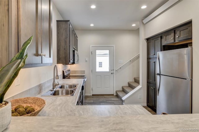 304 Barnwood Dr, Buena Vista, CO 81211 - kitchen with appliances with stainless steel finishes, recessed lighting, light countertops, dark brown cabinets, and wood finished floors