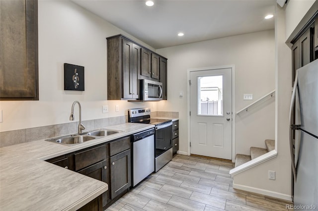 304 Barnwood Dr, Buena Vista, CO 81211 - kitchen featuring appliances with stainless steel finishes, dark brown cabinetry, light countertops, light wood-style flooring, and recessed lighting