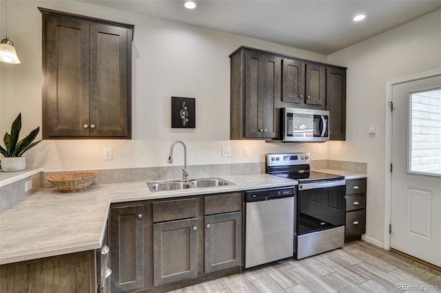 304 Barnwood Dr, Buena Vista, CO 81211 - kitchen with appliances with stainless steel finishes, dark brown cabinets, light countertops, recessed lighting, and hanging light fixtures