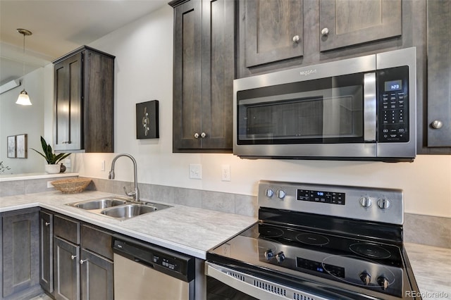 304 Barnwood Dr, Buena Vista, CO 81211 - kitchen featuring stainless steel appliances, dark brown cabinetry, light countertops, and pendant lighting