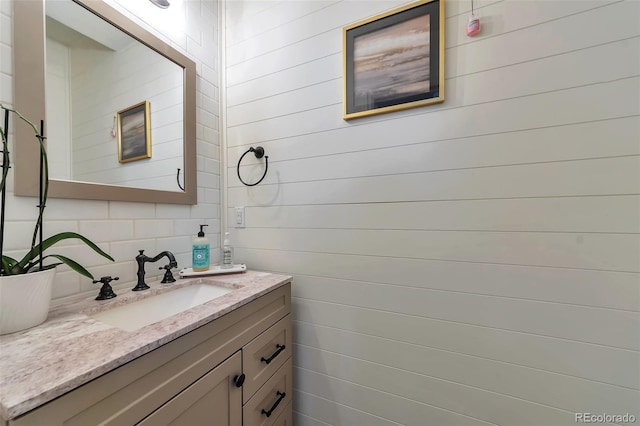 18096 E 104th Way, Commerce City, CO 80022 - bathroom featuring vanity and wood walls