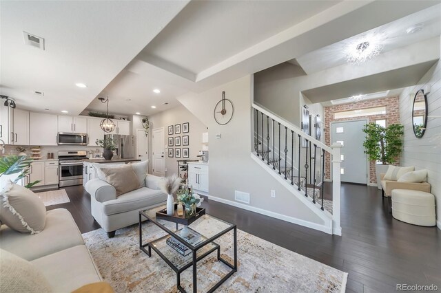 18096 E 104th Way, Commerce City, CO 80022 - living area featuring recessed lighting, dark wood-style flooring, stairway, and a chandelier