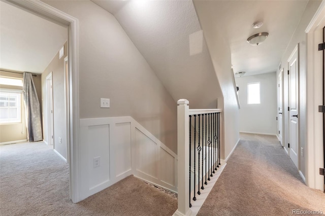 18096 E 104th Way, Commerce City, CO 80022 - corridor with carpet flooring, an upstairs landing, a decorative wall, and a wainscoted wall