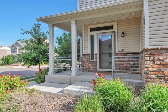 18096 E 104th Way, Commerce City, CO 80022 - view of exterior entry with a porch and stone siding