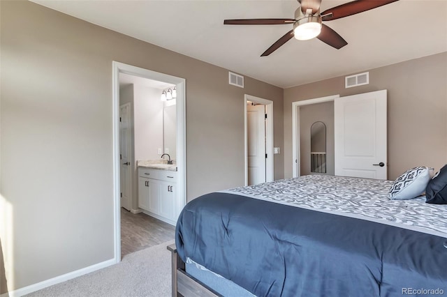 18096 E 104th Way, Commerce City, CO 80022 - bedroom featuring ensuite bathroom, ceiling fan, and light wood-style floors
