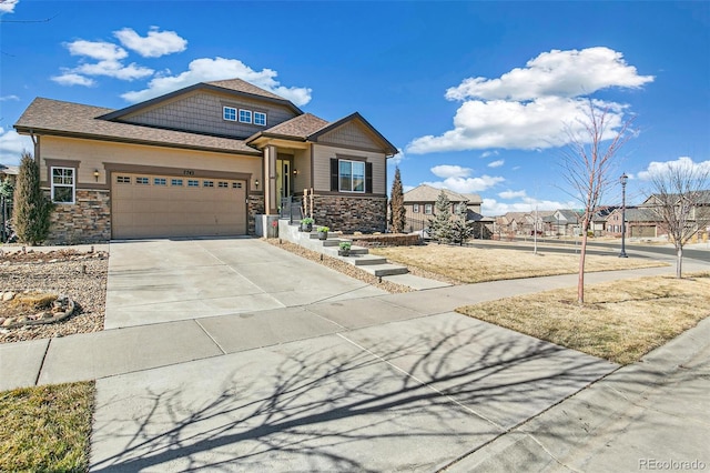 7743 S Quantock Way, Aurora, CO 80016 - craftsman-style home featuring stone siding, concrete driveway, and an attached garage