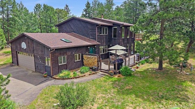 9745 Hilldale Dr, Morrison, CO 80465 - rustic home featuring a deck, a shingled roof, asphalt driveway, and a front yard