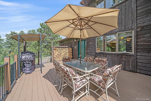 9745 Hilldale Dr, Morrison, CO 80465 - wooden terrace with outdoor dining area and area for grilling
