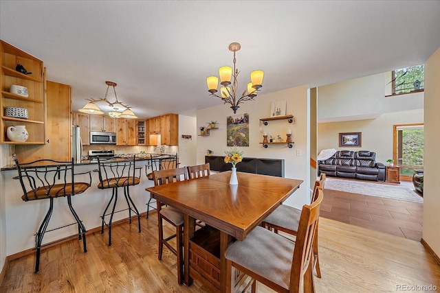 9745 Hilldale Dr, Morrison, CO 80465 - dining room with light wood-style flooring and a chandelier