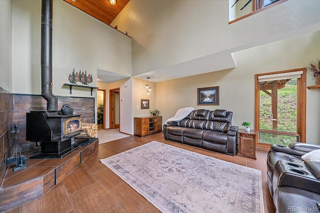 9745 Hilldale Dr, Morrison, CO 80465 - living area with high vaulted ceiling, a wood stove, and wood finished floors