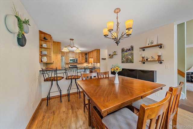 9745 Hilldale Dr, Morrison, CO 80465 - dining area with a chandelier and light wood-style flooring