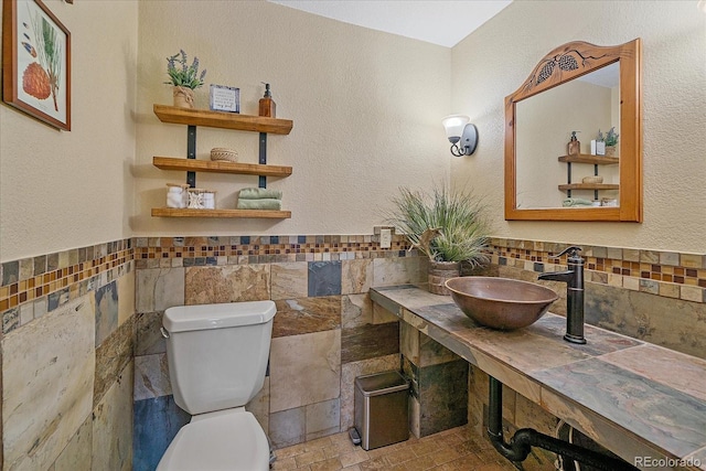 9745 Hilldale Dr, Morrison, CO 80465 - half bathroom featuring tile walls and wainscoting