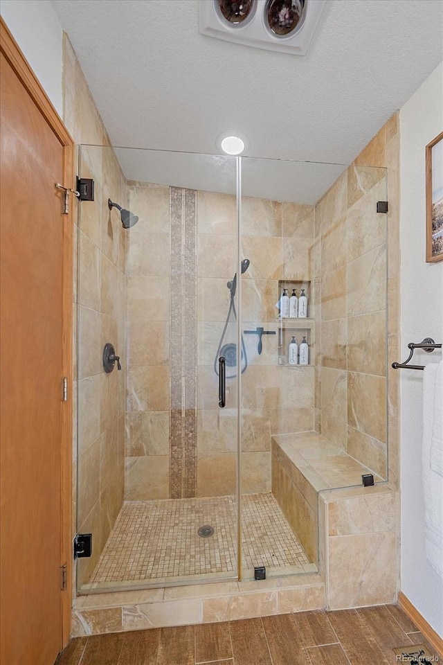 9745 Hilldale Dr, Morrison, CO 80465 - bathroom with a stall shower and wood finished floors