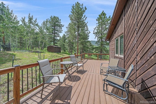 9745 Hilldale Dr, Morrison, CO 80465 - wooden terrace with a shed and a lawn