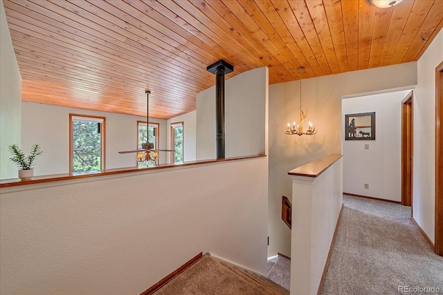 9745 Hilldale Dr, Morrison, CO 80465 - corridor featuring an upstairs landing, carpet, wooden ceiling, and a chandelier